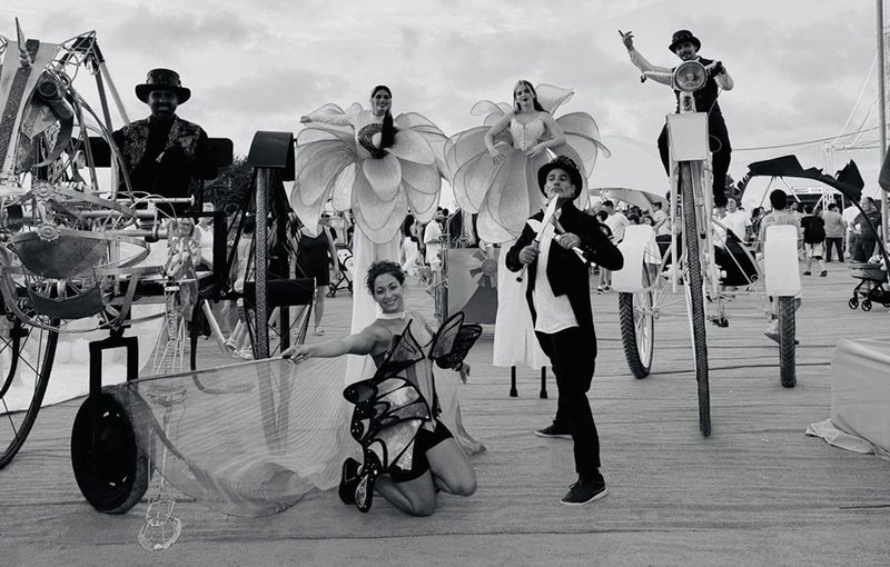 Elenco completo con vestuario blanco y negro y estructuras principales.